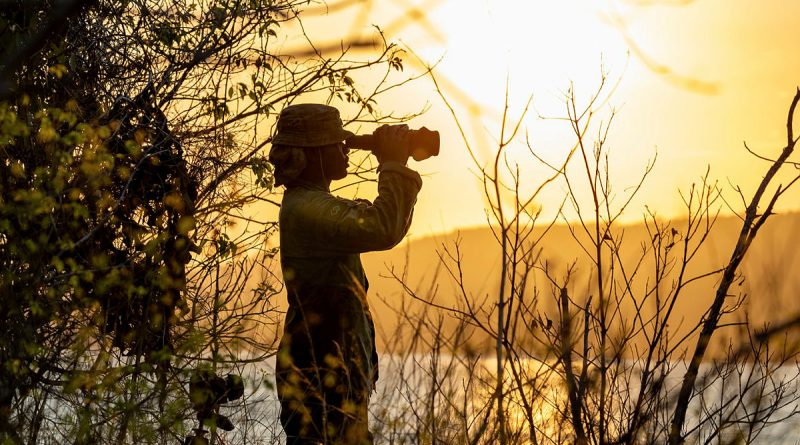 Private Leonard Harris, of NORFORCE, uses a spotting scope to conduct surveillance of the northern Kimberley region of WA. Story by Captain Katy Manning. Photo by Corporal Michael Currie.