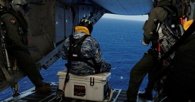 From left, Warrant Officer Steven Burrows, Leading Aircraftman Kurt Lewis and Sergeant Ben Richardson prepare to take photos of marine traffic during a ramp ride on board a C-27J Spartan during Operation Kuru Kuru, Fiji. Photos by Leading Aircraftman Kurt Lewis.