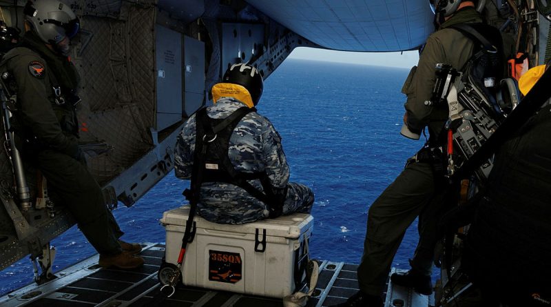 From left, Warrant Officer Steven Burrows, Leading Aircraftman Kurt Lewis and Sergeant Ben Richardson prepare to take photos of marine traffic during a ramp ride on board a C-27J Spartan during Operation Kuru Kuru, Fiji. Photos by Leading Aircraftman Kurt Lewis.