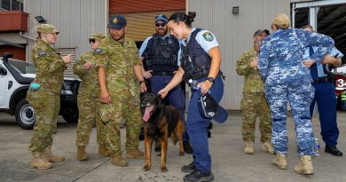 NSW Police Officer Constable Amanda Bliss pets military working dog, Nitro, during a Joint Military Police Unit Sydney community engagement day at RAAF Base Richmond. Story by Flying Officer Jamie Wallace. Photos by Leading Aircraftman Chris Tsakisiris.