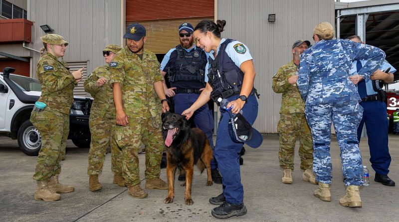 NSW Police Officer Constable Amanda Bliss pets military working dog, Nitro, during a Joint Military Police Unit Sydney community engagement day at RAAF Base Richmond. Story by Flying Officer Jamie Wallace. Photos by Leading Aircraftman Chris Tsakisiris.