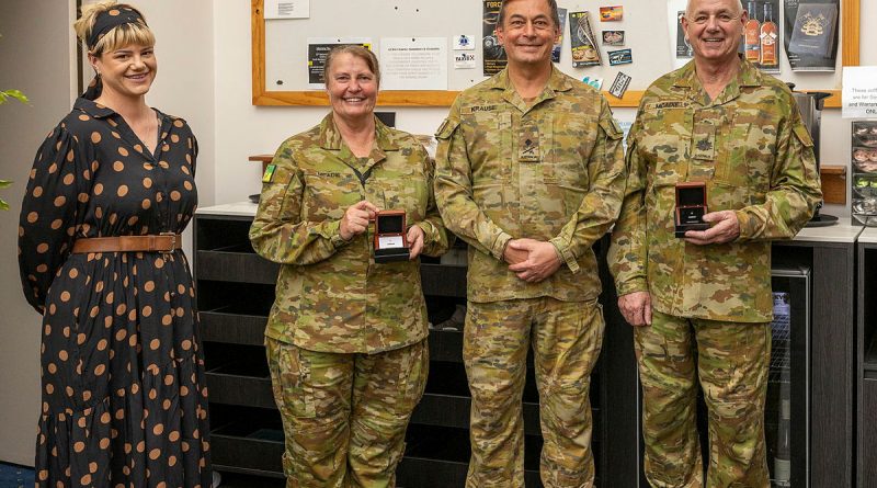 Army Major Wendi McAdie and Warrant Officer Class One Andrew McAdie are presented their Federation Star medals by Major General Michael Krause alongside their daughter, Clancy McAdie. Story by Captain Krysten Clifton. Photo by Michael Banovic.