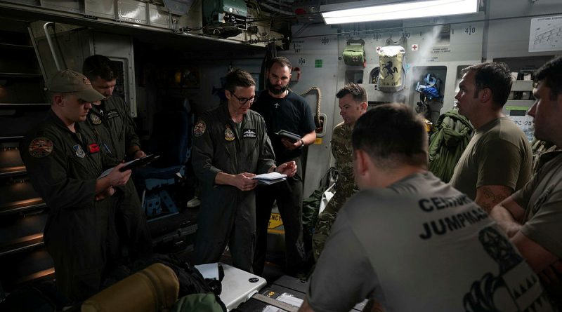 Flight Lieutenant Tom Breadon, of RAAF’s 36 Squadron, briefs mission details before a joint air-drop mission over Alaska. Story by Flight Lieutenant Nicole Thomson-Pride. Photos by Senior Airman Mark Sulaica (US Air Force).