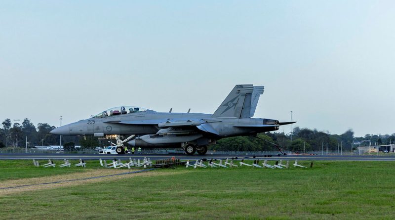 A RAAF EA-18G Growler lands using a Mobile Aircraft Arrestor System to demonstrate its capabilities at RAAF Base Amberley, Queensland. Story by Bruce Chalmers. Photo by Aircraftman Nell Bradbury.