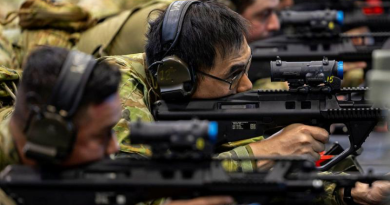 Leading Aircraftman Henry Lam, centre, uses the weapons training simulation system at RAAF Base Amberley, Queensland. Story by Corporal Michael Rogers. Photos by Leading Aircraftman Campbell Latch.