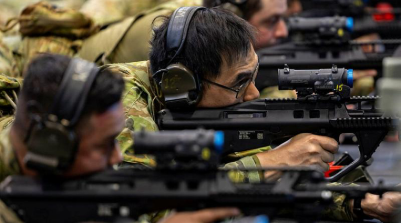 Leading Aircraftman Henry Lam, centre, uses the weapons training simulation system at RAAF Base Amberley, Queensland. Story by Corporal Michael Rogers. Photos by Leading Aircraftman Campbell Latch.