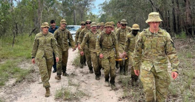 ADF Members and Queensland Ambulance Service personnel stretcher a man, who had been missing, through bushland to emergency service vehicles. Story by Lieutenant Commander Nic Hawkins. Photo from Queensland Police Service.