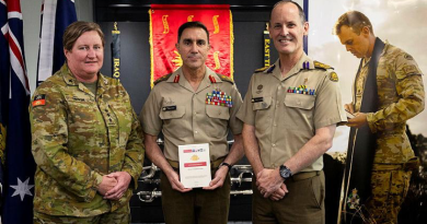 'Land Pub 0.0.3 Chaplaincy in War' is launched by Chief of Army Lieutenant General Simon Stuart, centre, with Chaplain Sarah Gibson, left, and Director General Chaplaincy - Army Principle Chaplain Kerry Larwill at Russell Offices in Canberra.