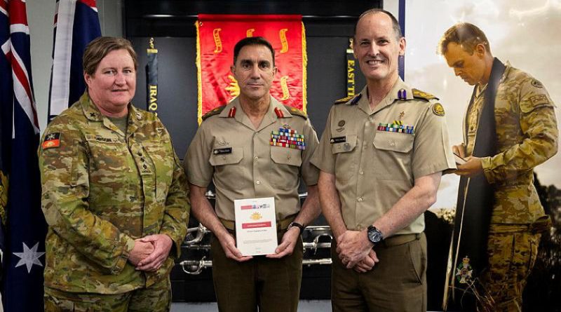 'Land Pub 0.0.3 Chaplaincy in War' is launched by Chief of Army Lieutenant General Simon Stuart, centre, with Chaplain Sarah Gibson, left, and Director General Chaplaincy - Army Principle Chaplain Kerry Larwill at Russell Offices in Canberra.