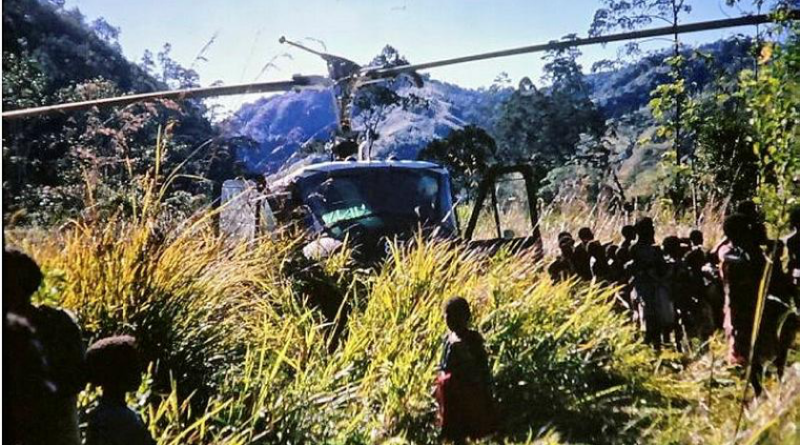 The crew of the A2-487 Iroquois, at a village near Garaina, PNG, seek witnesses to the crash of a RAAF Caribou in August 1972.