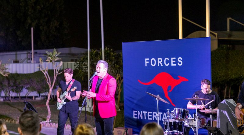 Phil Burton, centre, performs at Camp Baird Headquarters Middle East for deployed ADF personnel on Australia Day during the Forces Entertainment Tour. Story and photos by Leading Seaman Nadav Harel.