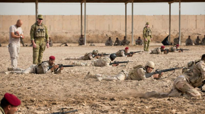 Australian Army Captain Anthony Davis, left, instructs Iraqi soldiers of the Taji Military Complex's Non-Commissioned Officer Academy as they practise fire and movement towards a notional enemy position at the Taji Military Complex, Iraq. Story and photos by Sergeant Matthew Bickerton.