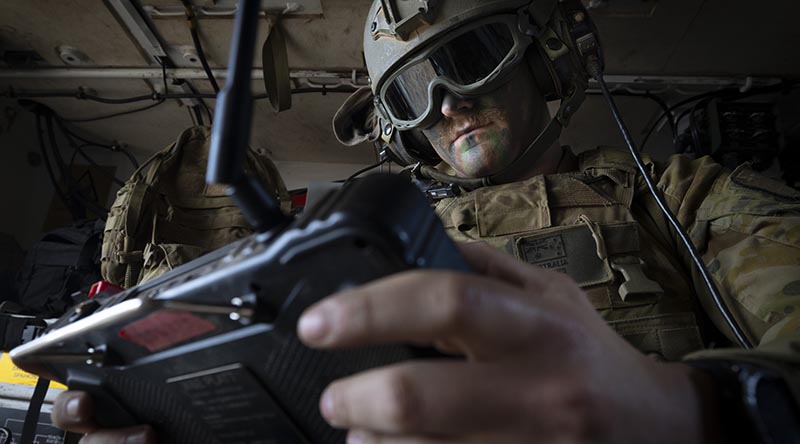 An Australian Army trooper from the 1st Armoured Regiment remotely controls a weapon system on an optionally crewed armoured vehicle during a demonstration in Puckapunyal, Victoria. Photo by Sergeant Tristan Kennedy.
