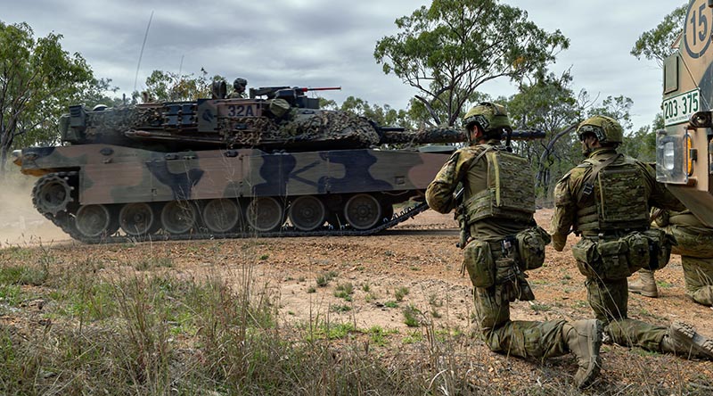 Soldiers look on as an Australian M1A1 Abrams tank passes by during Exercise Talisman Sabre 2023. Photo by Corporal Michael Currie.