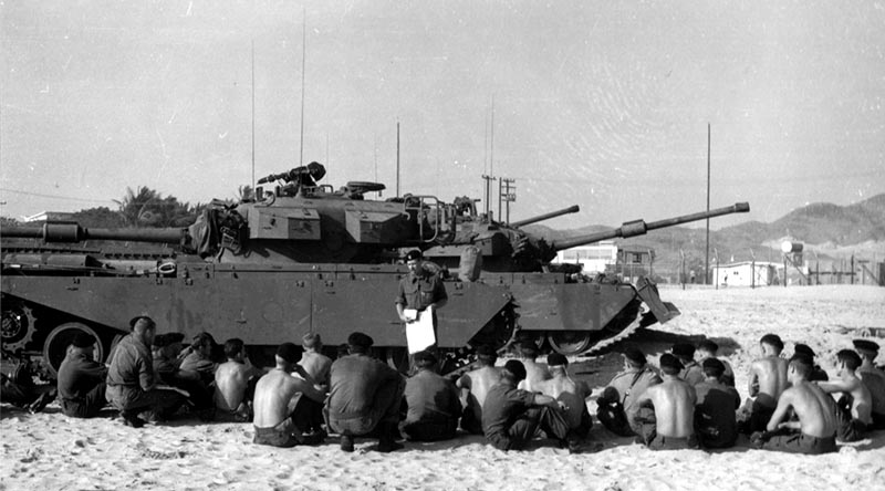 Soldiers of the 1st Armoured Regiment are briefed while sitting in front of their Centurion tanks at Vung Tau in South Vietnam during 1968. Photo by Starry, Donn A. Mounted combat in Vietnam. Department of the Army, via Wikipedia.