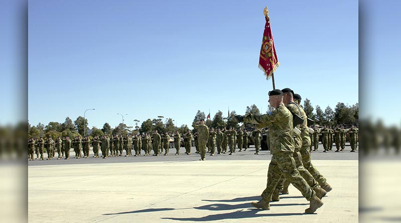 The Standard of the 1st Armoured Regiment is marched onto parade.