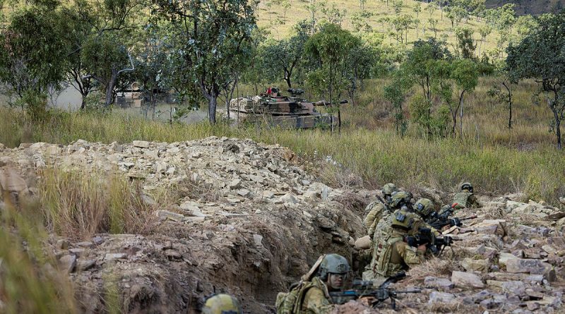 Soldiers from the 1st Battalion, the Royal Australian Regiment, conduct a trench clearance, supported by 2nd Cavalry Regiment M1A1 Abrams main battle tanks, as part of Exercise Brolga Sprint at Townsville Field Training Area, Qld. Story by Captain Brittany Evans. Photo by Private Jessica Gray.