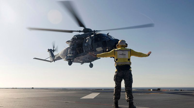 A Royal New Zealand Air Force NH90 aircraft lands on the flight deck of HMAS Canberra off the coast of Queensland. Story by Lieutenant Tahlia Merigan. Photos by Leading Seaman Connor Morrison.