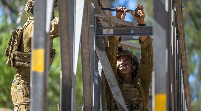 An Australian Army soldier from 6th Engineer Support Regiment, attaches a railing to a fixed modular bridge (FMB) during Exercise Talisman Sabre at Townsville Field Training Area, Queensland. Photo by Sergeant Roger Tang.