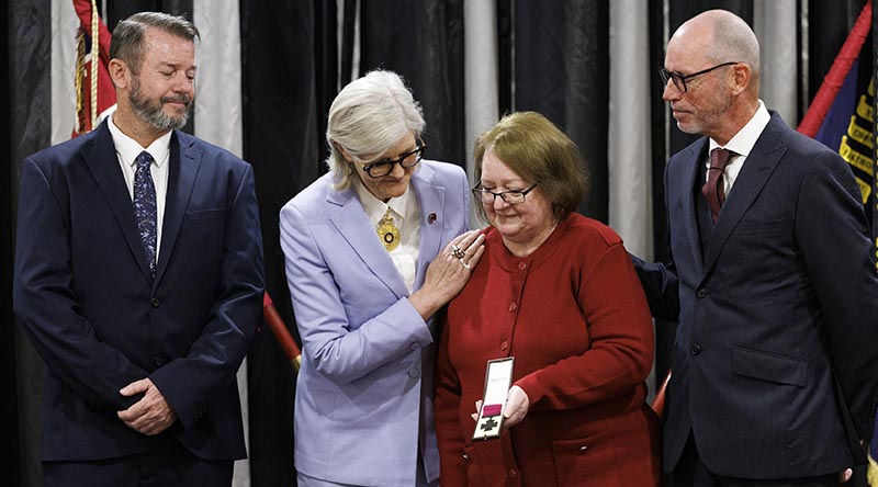 Governor General Sam Mostyn congratulates Robynn Freeman, widow of Private Richard Norden, after presenting her with her husband's Victoria Cross for Australia. Mrs Freeman is flanked by her and Richard's sons, Scott and Shane. Photos by Paul Berry.