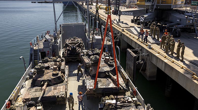 Australian Army soldiers from 2nd Cavalary Regiment, and United States Navy personnel, assist members from Depth Defence Logistics loading M1A2 SEPv3 Abrams main battle tanks to a United States Navy Loading Craft Utility during Exercise Talisman Sabre at the Townsville Port, Queensland. Photo by Lance Corporal Caitlyn Davill.