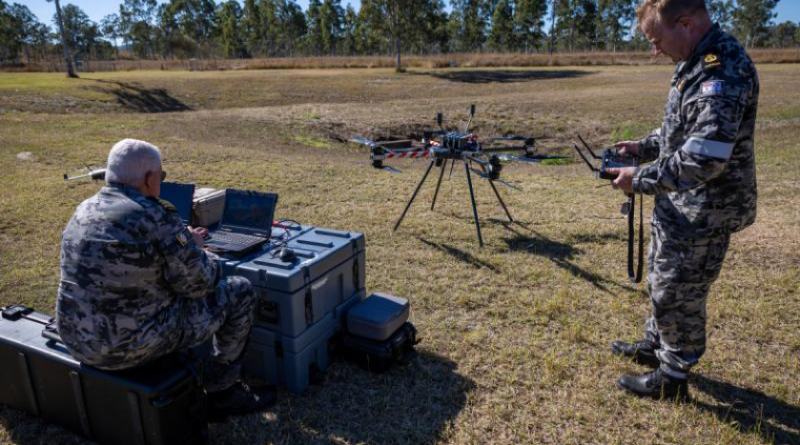 Commander Andrew Watson, left, and Chief Petty Officer Simon Hustwit prepare the Callisto 50 logistics drone for flight during a trial phase at Exercise Talisman Sabre. Story and photo by Corporal Michael Rogers.