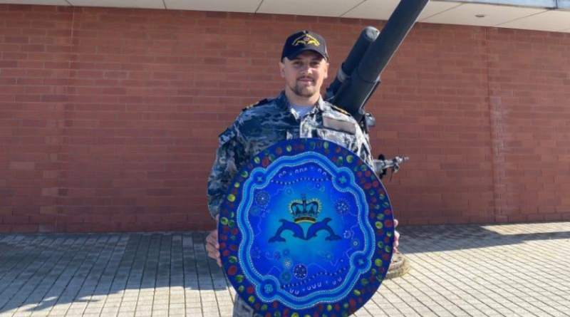 Lieutenant Steven Taylor holds his artwork designed for the Submarine Training and Systems Centre at HMAS Stirling. Story by Chief Petty Officer Maryanne Rowbottom. Photo supplied.