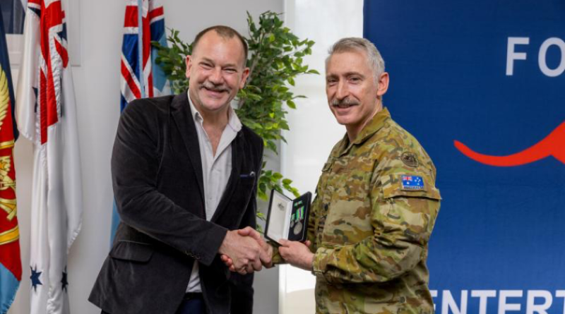 Comedian Anthony ‘Lehmo’ Lehmann is awarded the Australian Operational Service Medal (Civilian) by Deputy Theatre Commander Major General Paul Kenny in recognition 20 years of support to deployed troops. Story and photo by Leading Seaman Nadav Harel.
