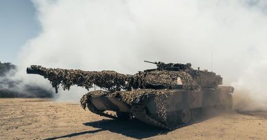 A M1A1 Abrams main battle tank puts out a smokescreen at Cowley Beach, Queensland. Photo by Leading Seaman David Cox.