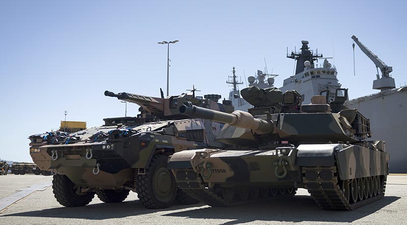 An Australian Army Boxer combat reconnaissance vehicle (left) and an M1A2 SEPv3 Abrams main battle tank during sea-transportability trials at Townsville Port, Queensland. Photo by Lance Corporal Caitlyn Davill.