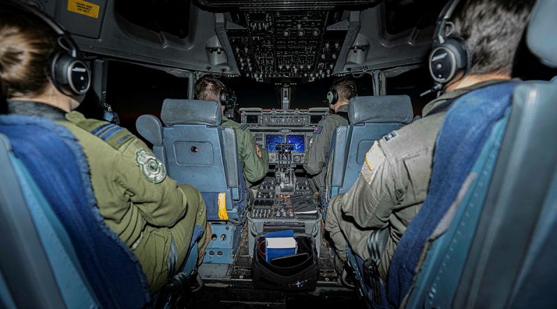 Pilots from four nations – the Royal Canadian Air Force, Royal Air Force, Royal Australian Air Force, second from right, and United States Air Force sit in the cockpit of a CC-177 Globemaster (701) during a flight to Canadian Forces Station Alert. Story by Taster Murdoch. Photos by Corporal Gwyneth Lovell, Canadian Armed Forces.