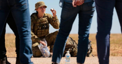 Sapper Veronica Bonner from 13th Engineer Regiment shows a combat ration pack to Army Reserve civilian employers at RAAF Base Curtin, Western Australia. Story by Corporal Michael Rogers. Photo by Corporal Andrew Sleeman.