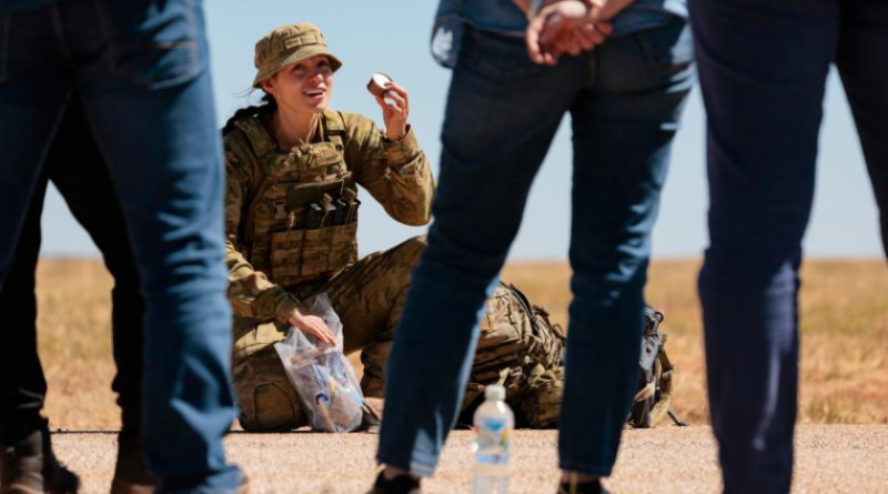 Sapper Veronica Bonner from 13th Engineer Regiment shows a combat ration pack to Army Reserve civilian employers at RAAF Base Curtin, Western Australia. Story by Corporal Michael Rogers. Photo by Corporal Andrew Sleeman.