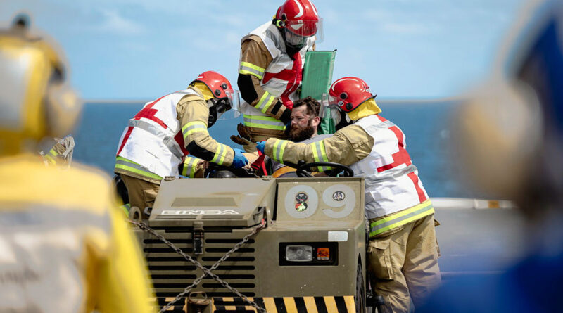 HMAS Canberra personnel attend to a simulated casualty during a crash-on-deck exercise while transiting off the coast of Queensland ahead of Exercise Sea Wader. Story by Captain Karam Louli. Photo by Able Seaman Jaxsen Shinners.