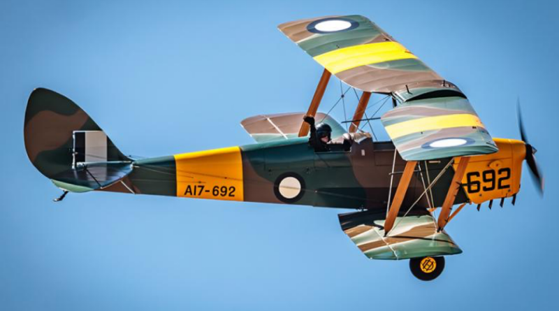An aviator from 100 Squadron flies a Tiger Moth heritage aircraft. Story by Flying Officer Rose Gigliotti. Photo by Duncan Fenn.