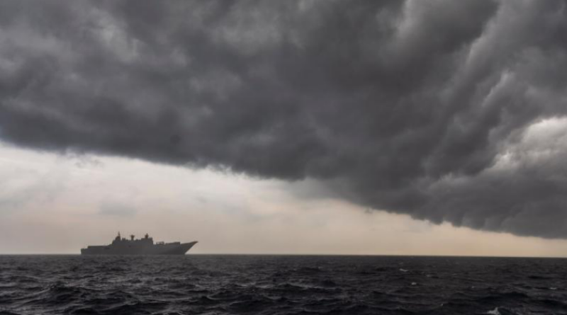 HMAS Adelaide sails into a rain cloud during Indo-Pacific Endeavour 2022. Story by Corporal Luke Bellman. Photo by Leading Seaman Sittichai Sakonpoonpol.
