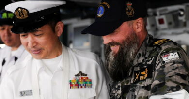 Warrant Officer Jonathan West talks with a Japan Maritime Self-Defense Force sailor on board JS Kumano as the ship transits to the Port of Brisbane. Story by Lieutenant Michael Wilson. Photos: byLeading Seaman Danyellah Hill.