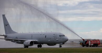 The 14th Royal Australian Air Force P-8A Poseidon gets a water-arch salute from aviation firefighters on arrival at RAAF Base Edinburgh, marking the fleet's completion. Photo by Flight Sergeant Rob Hack.
