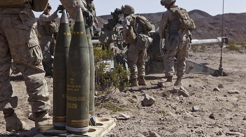 Marines from the 3rd Battalion, 12th Marine Regiment, stand ready to load M795 high explosive rounds into an M777 lightweight 155mm howitzer during a live-fire exercise in California. US Marine Corps photo by Lance Corporal Sean Searfus, 1st Marine Division.
