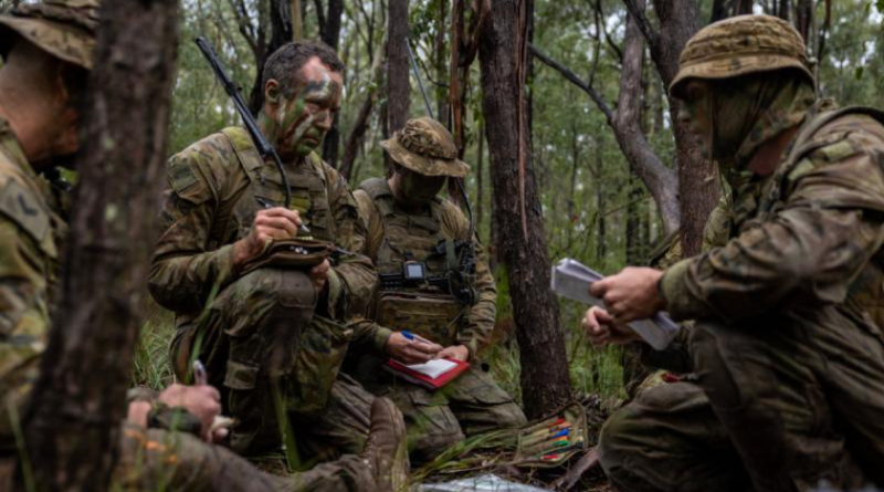 Private Michael Staszak, centre-left, receives orders from his platoon commander before a patrol as part of Exercise Menin Blade at Singleton Military Area, NSW. Story and photo by Corporal Michael Rogers.