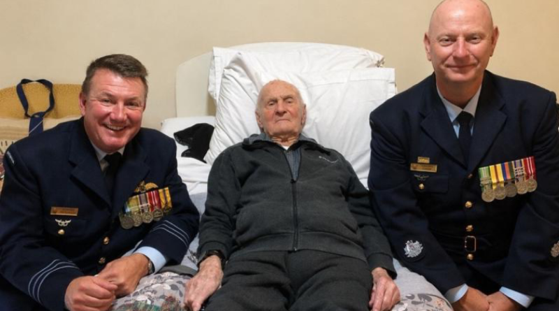 Commanding Officer 100 Squadron Wing Commander Richard Brougham, left, and 100 Squadron Warrant Officer Andrew Doyle, right, sit with Ted McConchie to watch the Anzac Day commemorations together. Story by Flying Officer Rose Gigliotti.