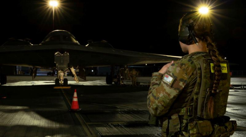 RAAF Leading Aircraftwoman Meilena Frolova patrols a US Air Force B-2 Spirit stealth bomber at RAAF Base Amberley, Queensland. Story by Wing Commander Pete Croce. Photo by Leading Aircraftwoman Aiesha White-Kratz.