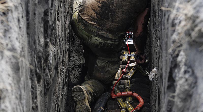 An Australian Army explosive ordnance disposal technician on Operation Render Safe 26 prepares a charge to destroy unexploded ordnance in Rabaul, Papua New Guinea. Photo by Sergeant Andrew Sleeman.