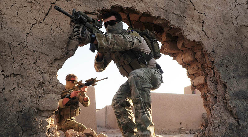 Special Operations Task Group (SOTG) members enter a training compound at Multi National Base Tarin Kowt (MNBTK). Photo by Corporal Chris Moore.