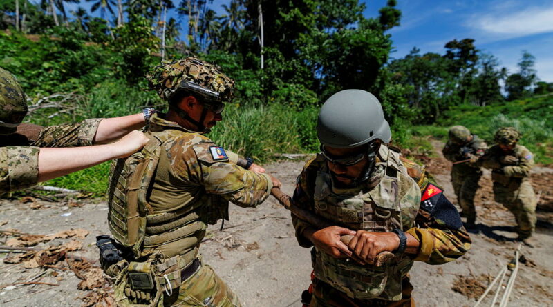 Explosive ordnance technicians from the Australian Army, PNG Defence Force and Canadian Armed Forces prepare to remotely move explosive ordnance during Operation Render Safe in East New Britain, PNG. Story by Captain Annie Richardson. Photo by Sergeant Andrew Sleeman.