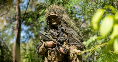 An Australian Army soldier conducts a patrol back to his position during Exercise Black Cutlass at Cape Cleveland, Queensland. Story by Captain Cody Tsaousis. Photo by Private Alli Craig.
