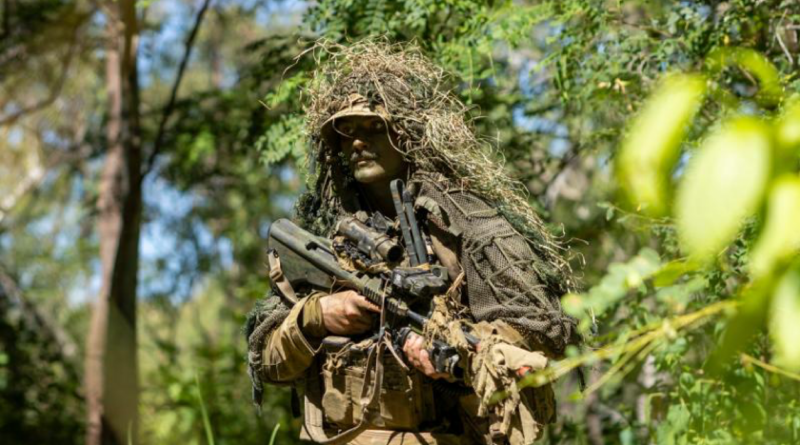 An Australian Army soldier conducts a patrol back to his position during Exercise Black Cutlass at Cape Cleveland, Queensland. Story by Captain Cody Tsaousis. Photo by Private Alli Craig.