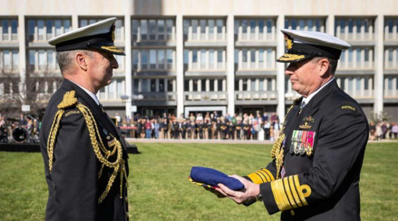 Outgoing Chief of the Defence Force (CDF) Admiral David Johnston hands over the CDF ensign to incoming CDF Admiral Mark Hammond during a ceremonial parade at Russell Offices, Canberra. Story by Sergeant Matt Bickerton. Photo by Kym Smith.