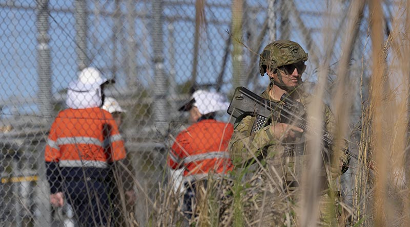 A member of Joint Task Force 629 provides security for Powerlink Queensland at its Calliope Substation – considered critical infrastructure for Queensland’s electricity network. Photo by Private Ryahn Rahme.