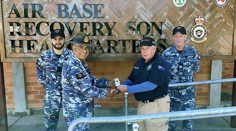 David Humphry receives his Veteran Defence Common Access Card from Squadron Leader Lancelot Monteiro, alongside Flying Officer Reece Jansen, left, and Warrant Officer Wayne Wilson, right.
